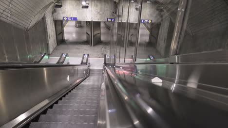 POV-Of-A-Person-Riding-Escalator-And-Going-Down-Inside-The-Subway-Station-Of-Nationaltheatret-In-Oslo,-Norway-During-COVID-19-Pandemic
