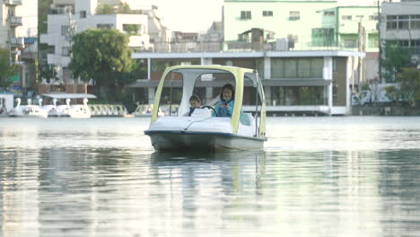 Mother-And-Daughter-Riding-Paddle-Boat-On-Calm-Water-In-Tokyo,-Japan-During-COVID-19-Pandemic