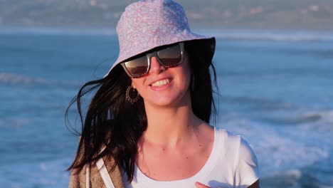beautiful-girl-portrait-with-bucket-hat-on-the-beach,-pichilemu,-punta-de-lobos