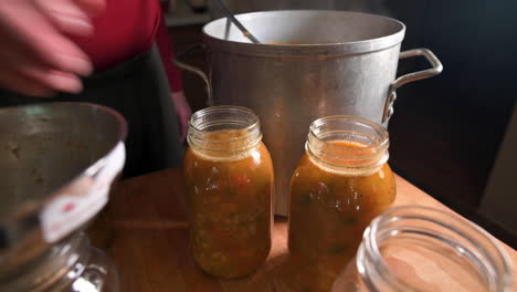 Preparing-Freshly-Cooked-Minestrone-Soup-In-Ball-Mason-Jars-For-Canning---high-angle,-close-up