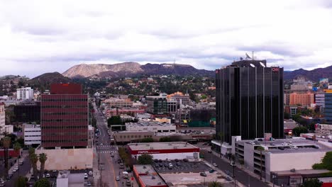 Aerial-rising-shot-of-downtown-Hollywood-with-the-Hollywood-sign