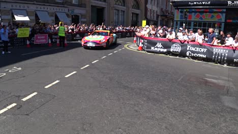 Multicolored-Racing-cars-driving-on-the-road-during-sunny-day-in-London