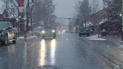 Christmas-village-street-decorated-traffic-lights-at-snowfall-and-light-traffic
