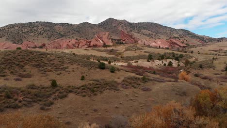 Aerial-shot-of-Red-rocks-amphitheater-gaining-altitude-in-the-fall