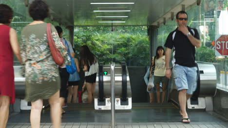 Singapore---Circa-Time-lapse-people-on-escalator-travel-up-and-down-from-upper-landing-platform-Concept:-people-moving