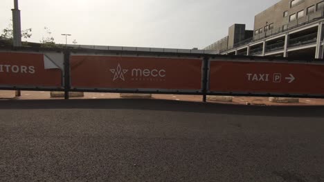 A-backwards-moving-shot-of-a-red-banner-with-the-name-MECC