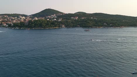 Evening-panorama-over-boats-coming-to-harbour-and-the-Franjo-Tudman-bridge-in-Dubrovnik,-Croatia