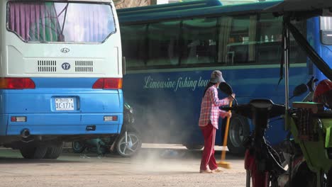 A-Lady-Sweeping-the-Dust-at-the-Bus-Station