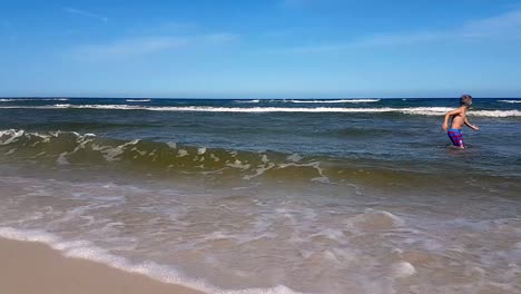 Waves-On-Sandy-Beach-On-A-Sunny-Day-Slowmotion-Shot