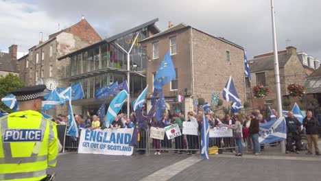 A-police-officer-watches-Scottish-protesters-outside-the-Perth-Concert-Hall-where-the-Tory-Leadership-Hustings-is-being-held