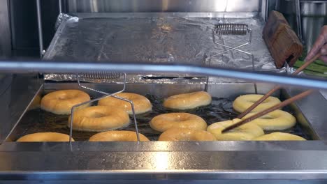 Doughnuts-in-a-fryer-being-flipped