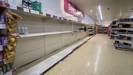 Empty-shelves-with-no-customers-around-in-the-beer-and-wine-section-of-the-supermarket-Sainsbury's-in-London-during-the-Coronavirus-pandemic