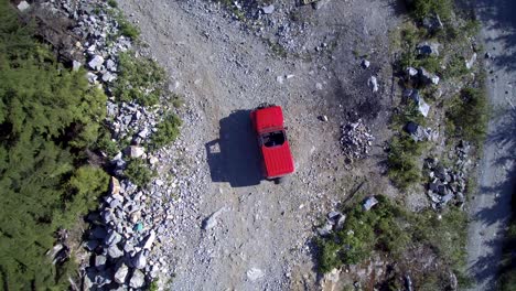 a-twirling-aerial-of-a-Jeep-Wrangler-parked-on-the-back-roads-surrounded-by-trees
