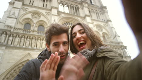 Happy-young-couple-waving-during-a-video-call