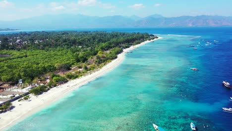 flying-over-white-sand-beach-tropical-sea-green-forest-turquoise-water-coral-reef