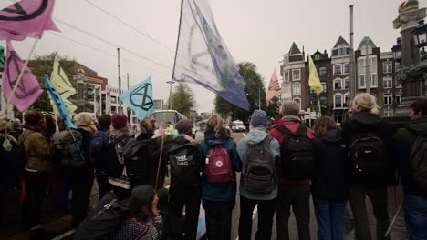 People-protesting-at-a-extinction-rebellion-climate-strike-in-Amsterdam-as-seen-from-police-blockade
