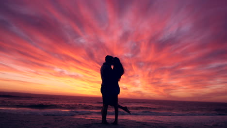 Couple,-silhouette-with-kiss-at-beach-and-sunset