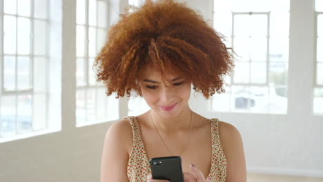 Woman-with-an-afro-texting-on-phone