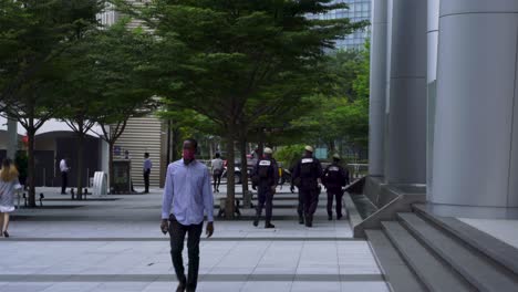Group-of-policemen-walking-at-Marina-Bay,-Downtown-Singapore