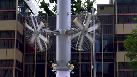 Outdoors-fans-on-against-office-building,-Singapore