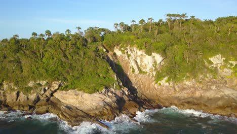 Aerial-dolly-out-shot-of-the-Trilha-da-Sepultura-at-golden-hour-in-Bombinhas,-Brazil