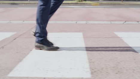 Closeup-of-feet-walking-over-a-public-crossing