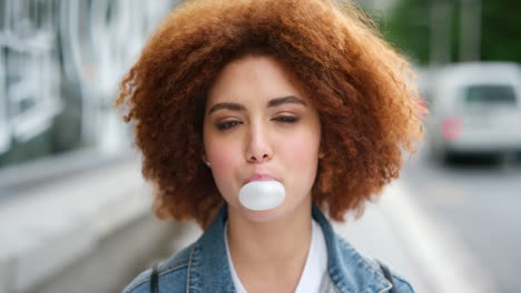 Portrait-of-an-edgy-girl-with-afro-blowing-bubble