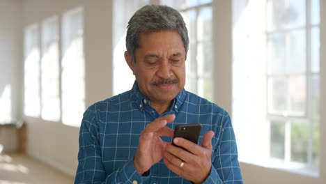 Mature-business-man-using-phone-for-online