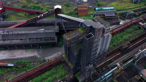 Aerial-view-of-people-camping-on-an-abandoned-steel-factory-with-urban-background