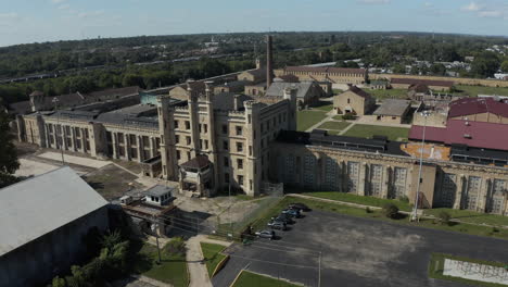 Aerial-view-tracking-around-the-entrance-of-Joliet-Prison,-an-iconic-historical-landmark-now-abandoned-and-derelict,-Chicago,-Illinois,-United-States