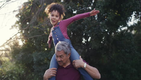 Fun-grandfather-carrying-playful-child