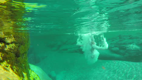 Woman-in-a-red-bikini-swimming-underwater