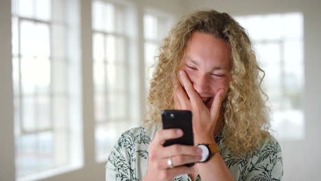 Composite-of-laughing-man-texting-on-a-phone
