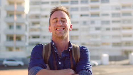 Portrait-of-smiling-tourist-carrying-backpack
