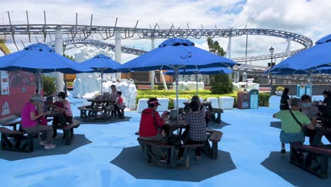 Visitors-eat-during-lunchtime-next-to-the-Artic-Blast-roller-coaster-ride-at-the-amusement-and-animal-theme-park-Ocean-Park-in-Hong-Kong