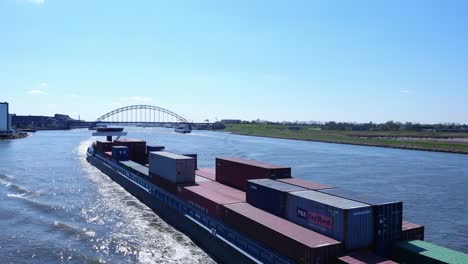 Stack-Of-Intermodal-Containers-On-Barge-Cruising-At-Noord-River-Near-Hendrik-Ido-Ambacht,-Netherlands