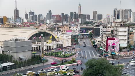 Traffic-On-City-Road-With-View-Of-Hua-Lamphong-Train-Station-And-Bangkok-Skyline-In-Thailand