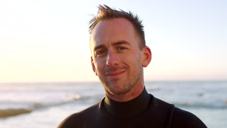 Portrait-of-a-handsome-male-surfer-in-a-wetsuit-by