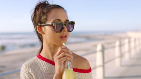 Woman-drinking-a-healthy-juice-on-a-beach-day