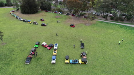 Moke-Owners-Association-50th-Anniversary-Convoy---Mokes-being-lined-up-perfectly-for-a-large-word-sign-including-many-owners-of-the-automotive-club