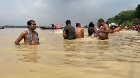 Close-up-video-of-people-taking-ritual-bath-in-the-river-Ganga-in-early-morning-in-Kolkata