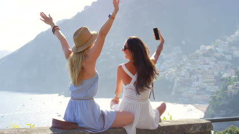 Two-friends-celebrating-and-taking-selfies
