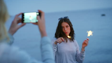 Sparklers,-beach-and-friends-with-phone-taking