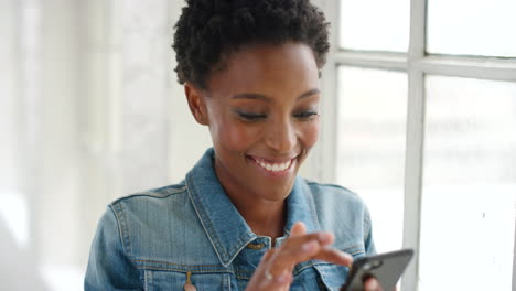 Happy-young-African-woman-using-phone