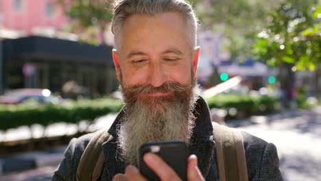 Mature-male-hipster-texting-on-a-phone