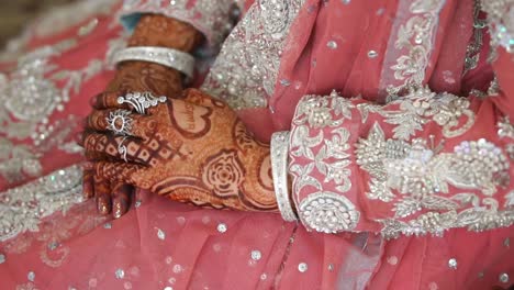 Vibrant-Henna-Mehndi-Design-On-Bride-Wearing-Pink-Outfit-With-Silver-Bangles