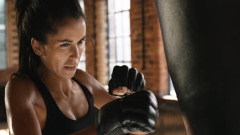 Strong-young-woman-focused-on-the-punching-bag