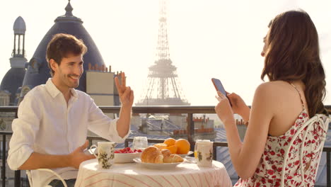 a-young-couple-having-breakfast-on-the-balcony