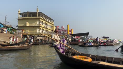Passagiere-In-Lokalen-Bootstaxis,-Die-Am-Flussufer-Des-Flusses-Buriganga-In-Dhaka-Ankommen