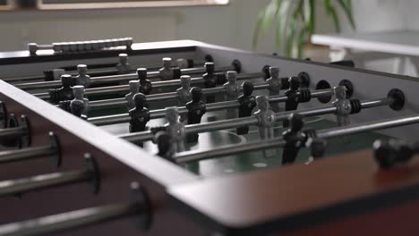Table-soccer-game-in-an-office---modern-work-life-lunch-break---close-up-slowmotion